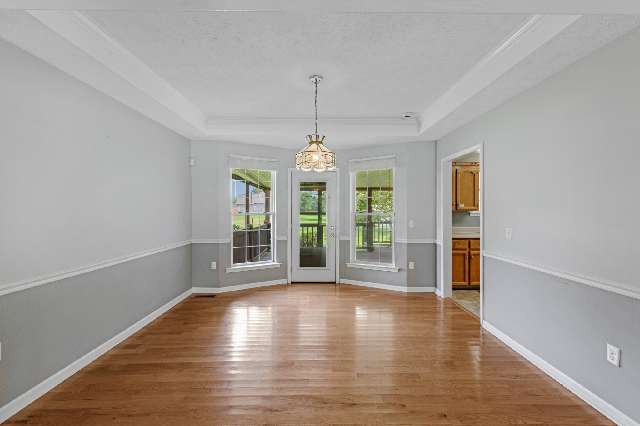 212 Independence Street Springfield, TN 37172 - Photo 8 of 26 an empty room with wooden floor chandelier and windows