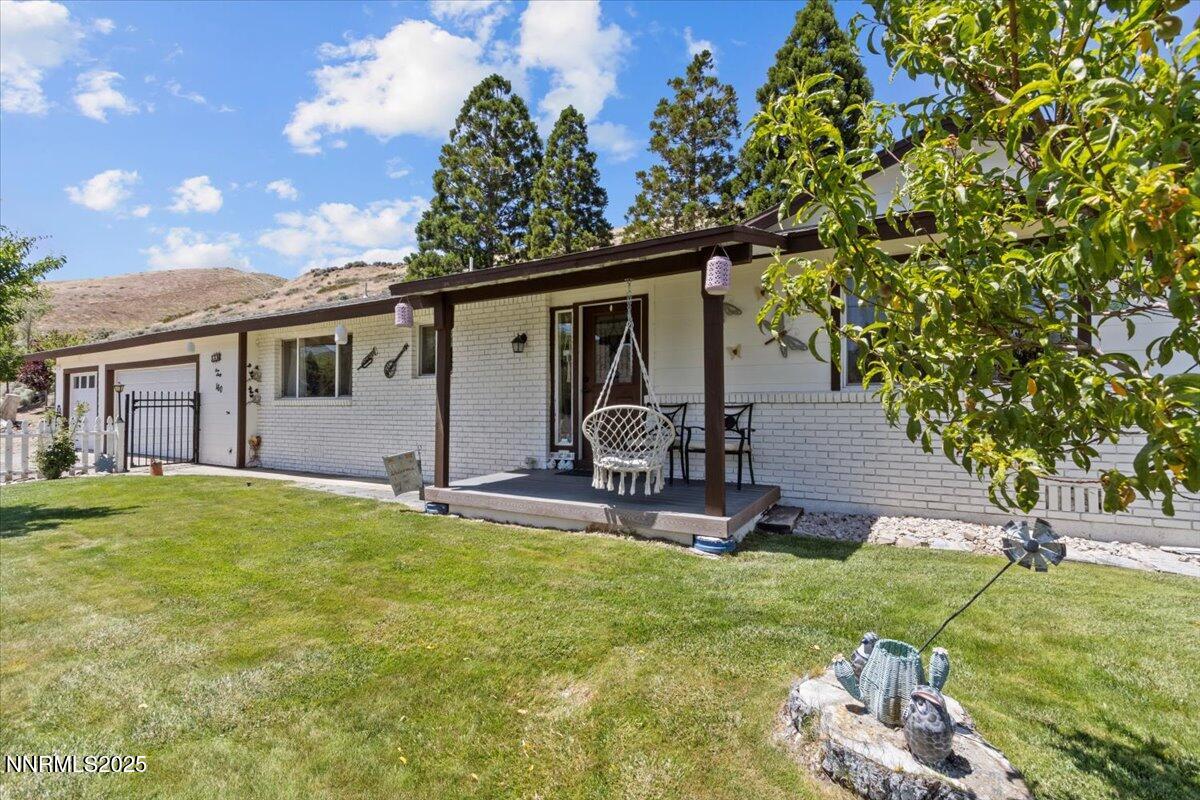 160 Cheyenne Drive Reno, NV 89521 - Photo 29 of 32 a view of a backyard with table and chairs and a tree