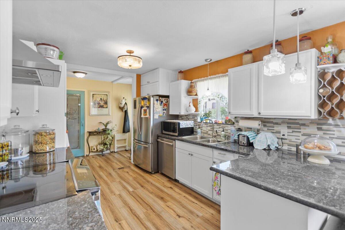 160 Cheyenne Drive Reno, NV 89521 - Photo 5 of 32 a kitchen with stainless steel appliances kitchen island granite countertop a sink and cabinets