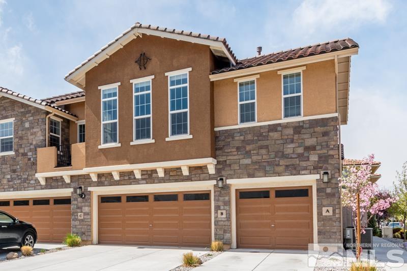 2024 Wind Ranch Road, Unit B Reno, NV 89521 - Photo 1 of 18 a front view of a house with a garage