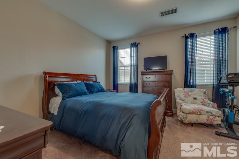 2024 Wind Ranch Road, Unit B Reno, NV 89521 - Photo 11 of 18 a bedroom with a bed and a television