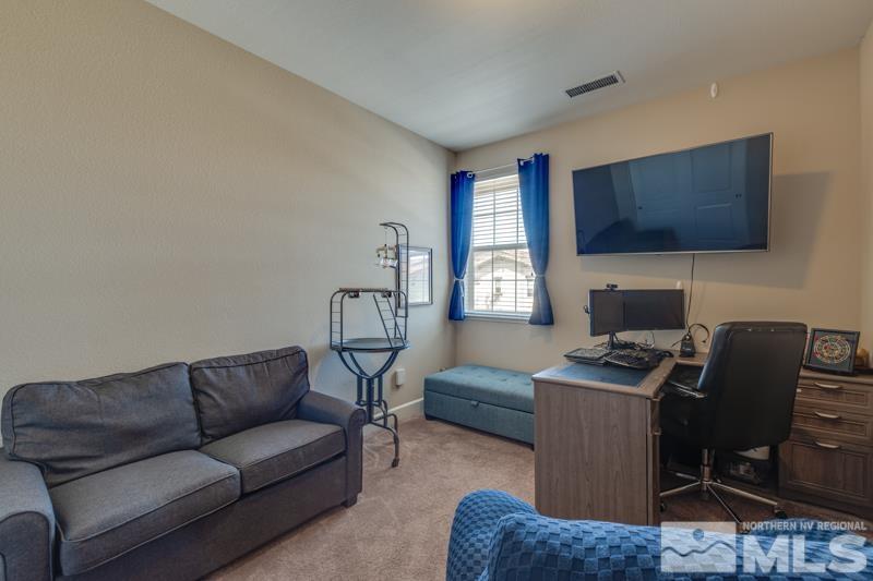 2024 Wind Ranch Road, Unit B Reno, NV 89521 - Photo 15 of 18 a living room with furniture a flat screen tv and a window