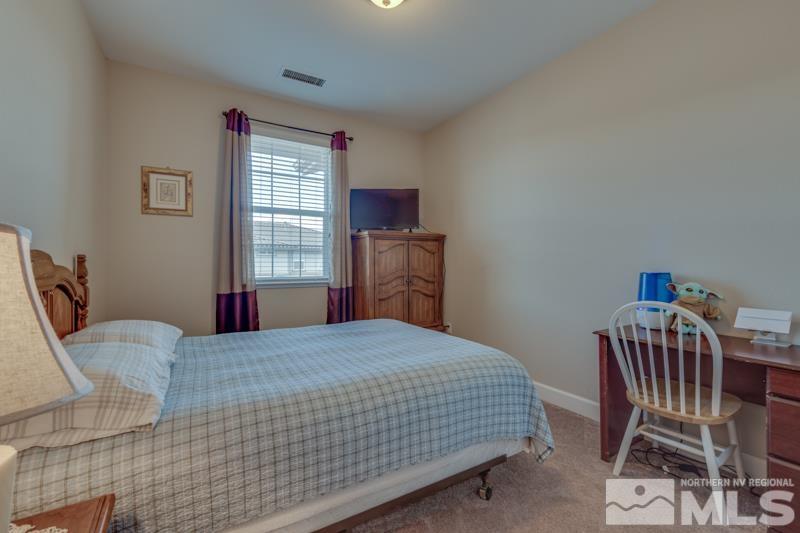 2024 Wind Ranch Road, Unit B Reno, NV 89521 - Photo 17 of 18 a bedroom with a bed chair and window