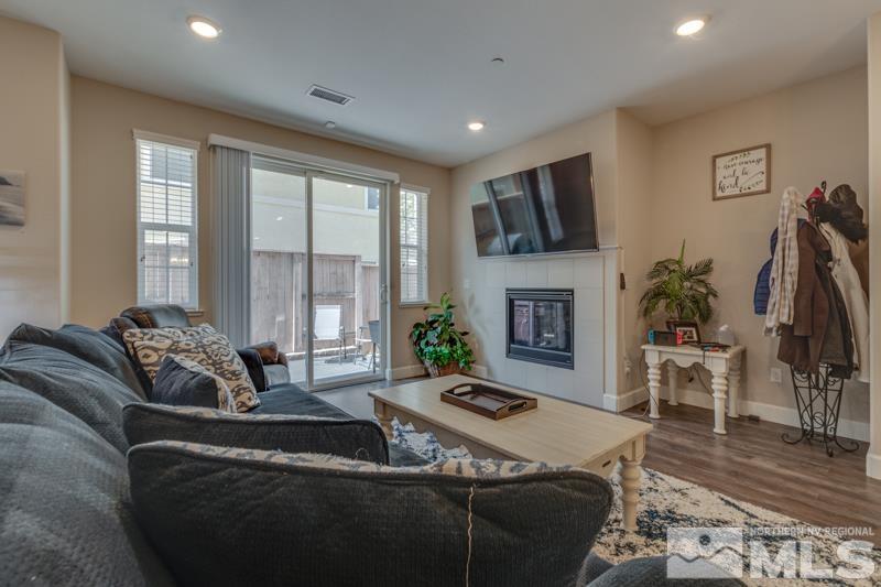 2024 Wind Ranch Road, Unit B Reno, NV 89521 - Photo 4 of 18 a living room with furniture fireplace and a flat screen tv