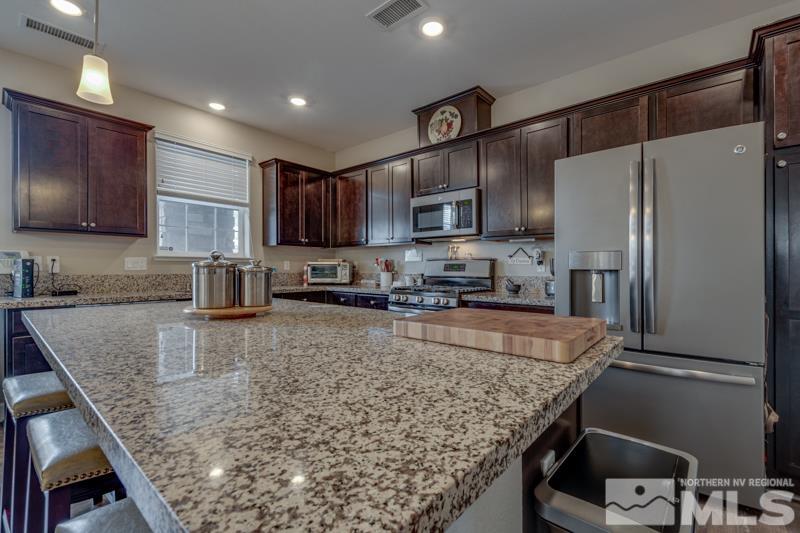 2024 Wind Ranch Road, Unit B Reno, NV 89521 - Photo 8 of 18 a kitchen with stainless steel appliances granite countertop a refrigerator a stove a sink a microwave and a refrigerator