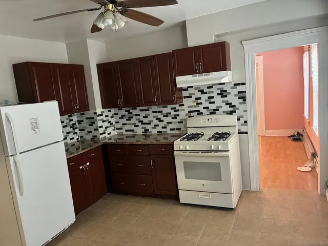 a kitchen with a refrigerator and a stove
