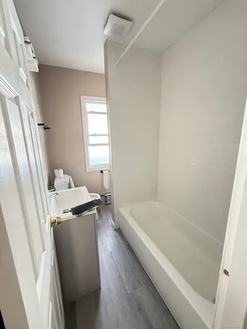 a bathroom with a bathtub and a shower