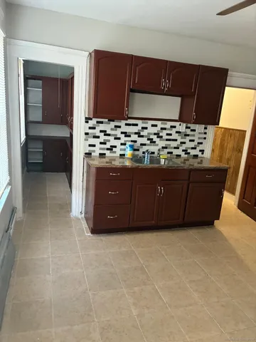 a living room with a couch and a stove top oven