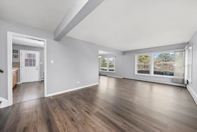wooden floor in an empty room with a window