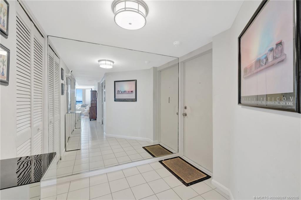 9500 South Ocean Drive, Unit HIGHER Jensen Beach, FL 34957 - Photo 26 of 53 a view of a hallway with wooden floor