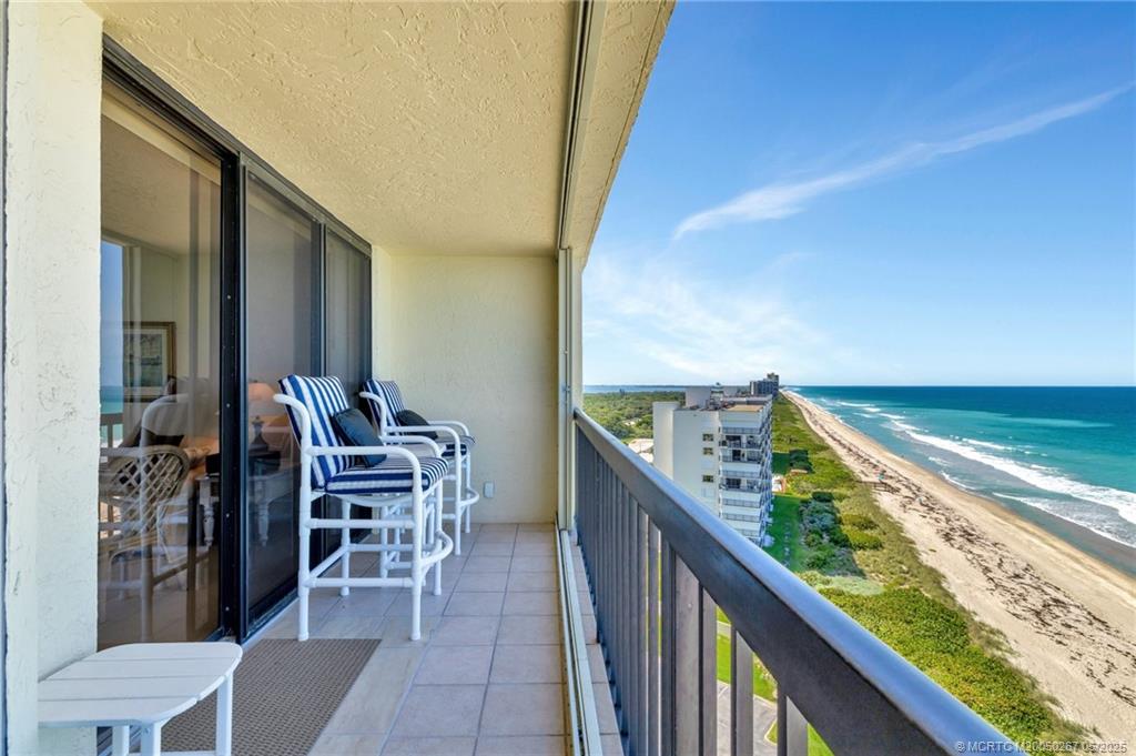 9500 South Ocean Drive, Unit HIGHER Jensen Beach, FL 34957 - Photo 45 of 53 a balcony with chairs and a table