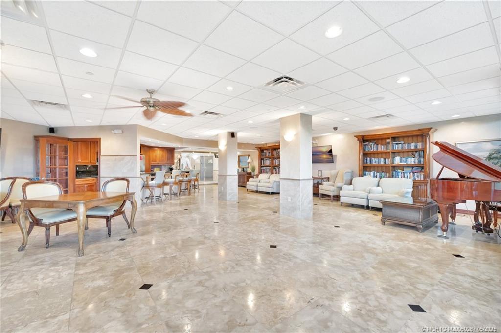 9500 South Ocean Drive, Unit HIGHER Jensen Beach, FL 34957 - Photo 52 of 53 a living room with lots of furniture and a chandelier