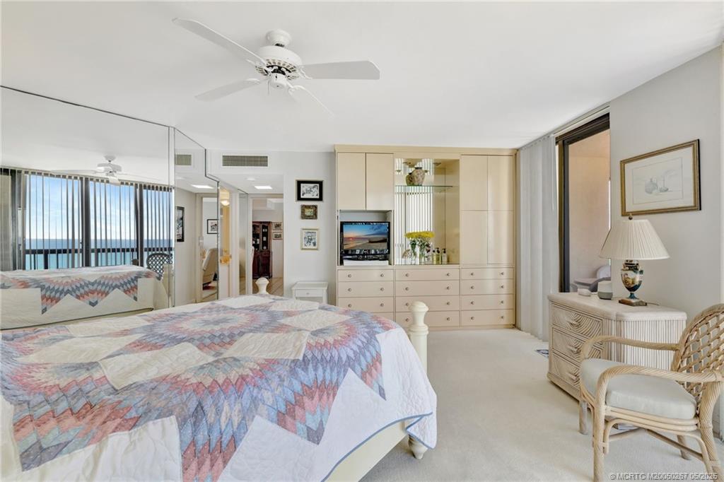9500 South Ocean Drive, Unit HIGHER Jensen Beach, FL 34957 - Photo 9 of 53 a bedroom with a bed a large window and furniture