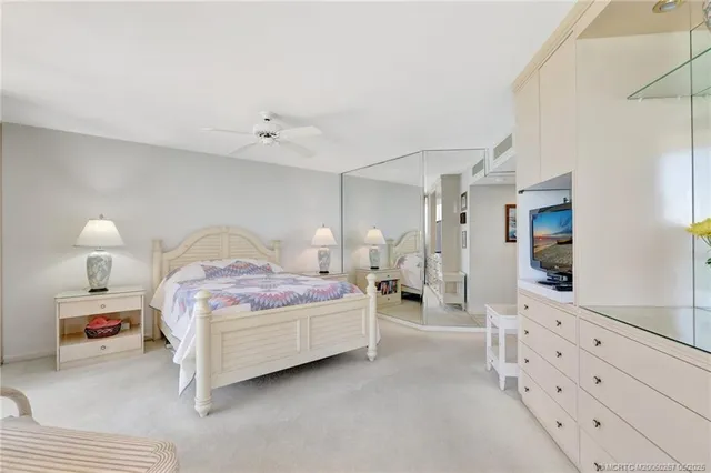 a bedroom with a bed and a lamp on dresser