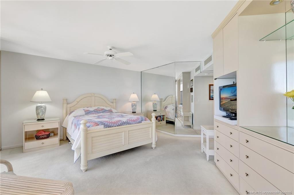 9500 South Ocean Drive, Unit HIGHER Jensen Beach, FL 34957 - Photo 10 of 53 a bedroom with a bed and a lamp on dresser