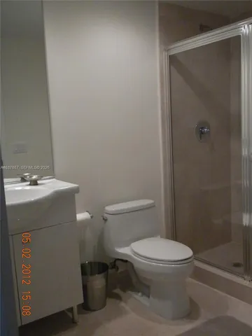 a bathroom with a toilet a sink and shower