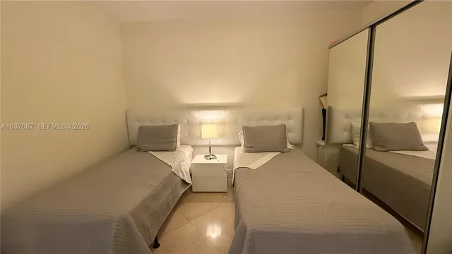 a bedroom with a bed and a lamp