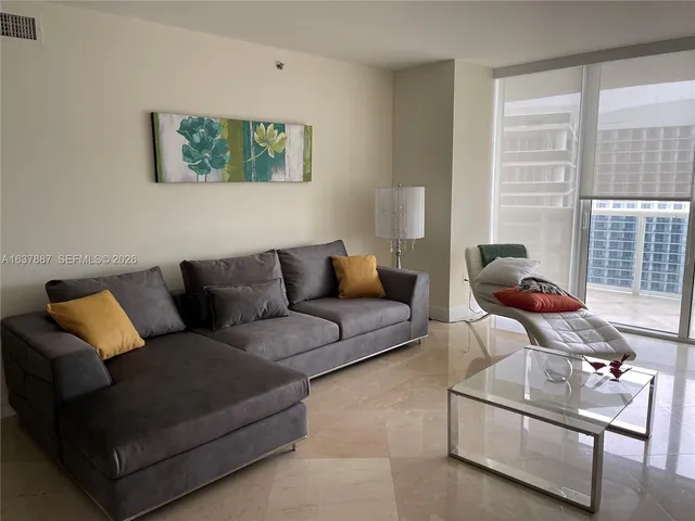 a living room with furniture and a window