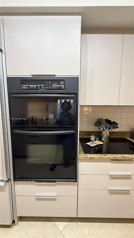 a stove top oven sitting inside of a kitchen