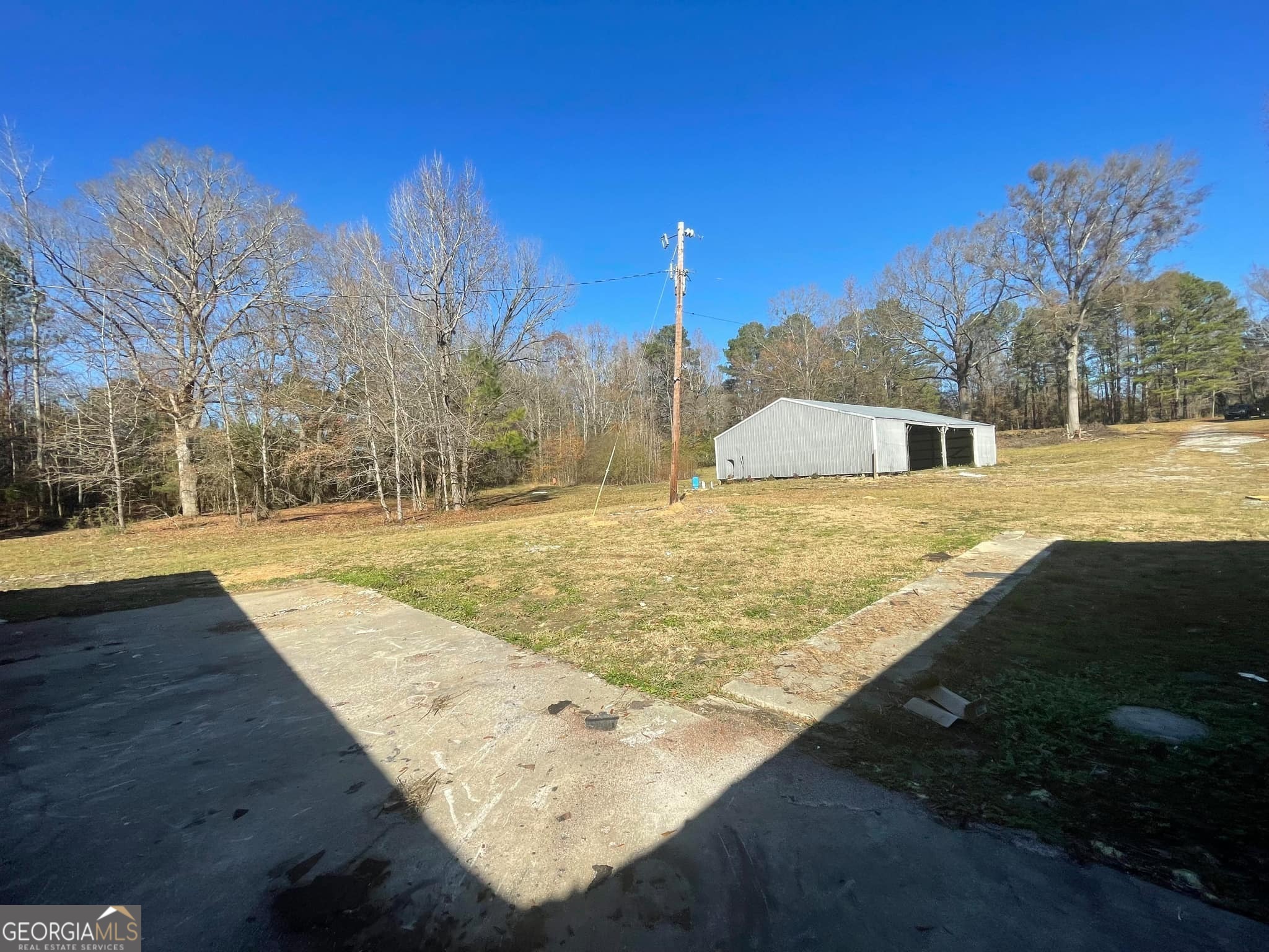 998 Campbell Road Meansville, GA 30256 - Photo 19 of 30 a view of yard with swimming pool and trees