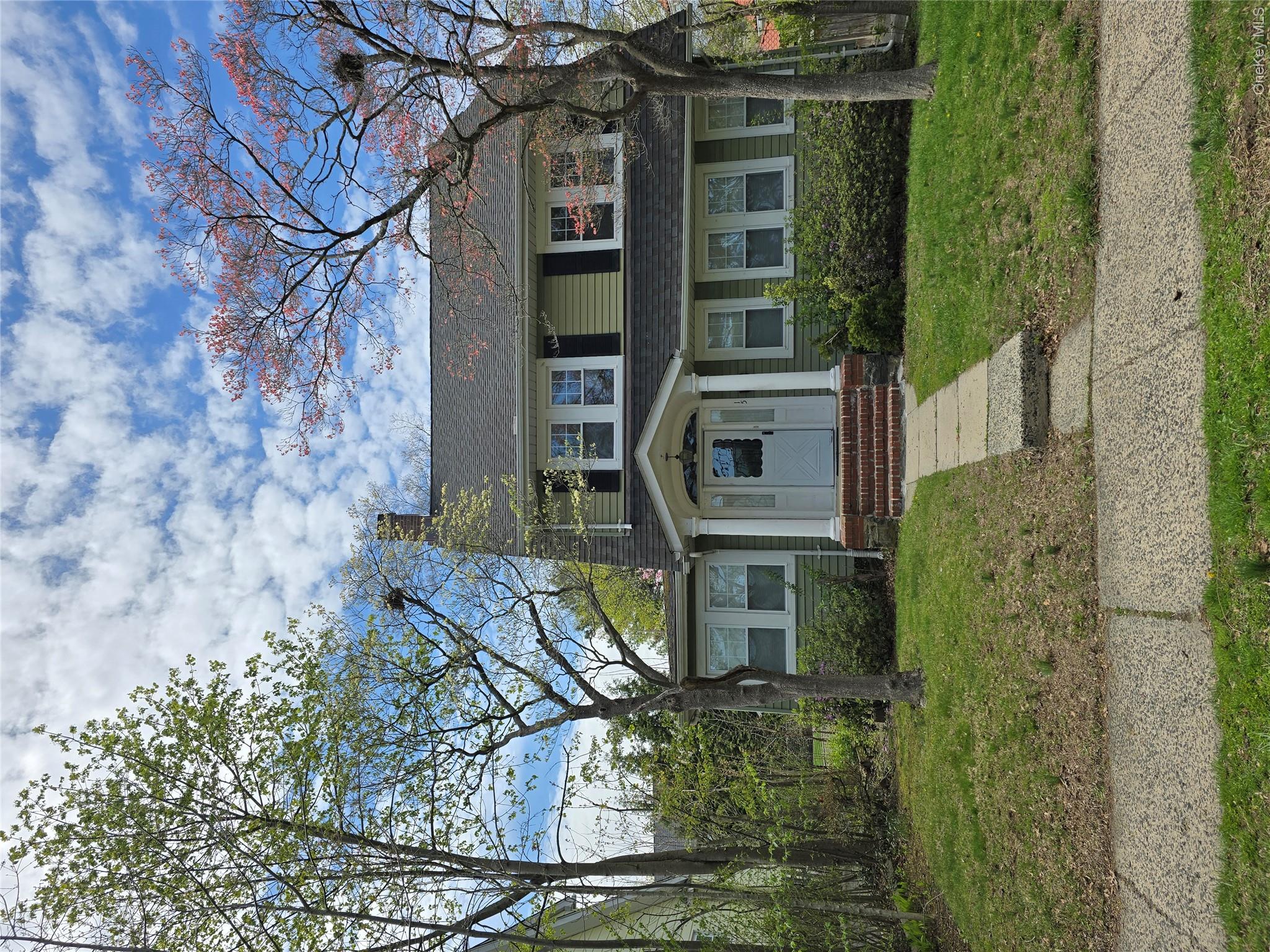 15 Roosevelt Avenue Rye, NY 10580 - Photo 1 of 13 a front view of a house with a yard