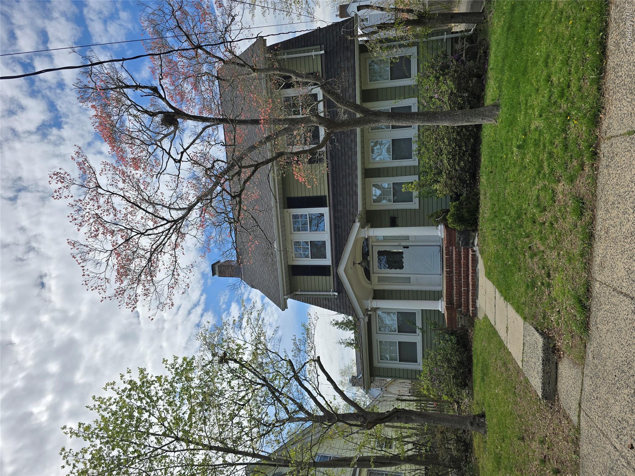 15 Roosevelt Avenue Rye, NY 10580 - Photo 13 of 13 a front view of a house with a garden