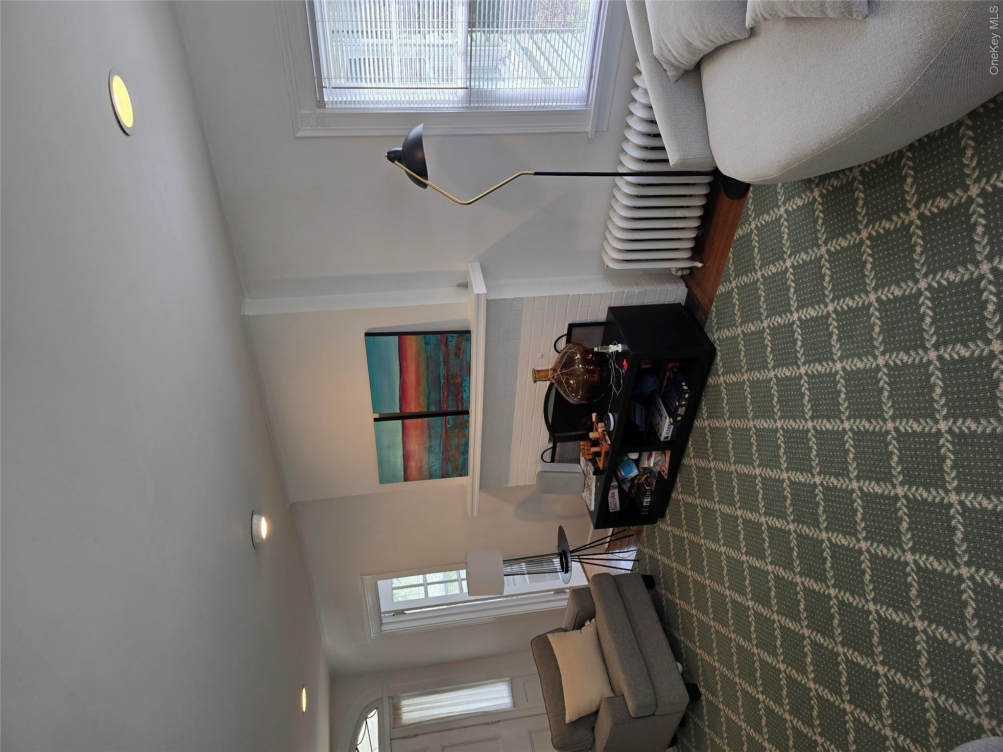15 Roosevelt Avenue Rye, NY 10580 - Photo 4 of 13 a living room with furniture a rug and a fireplace