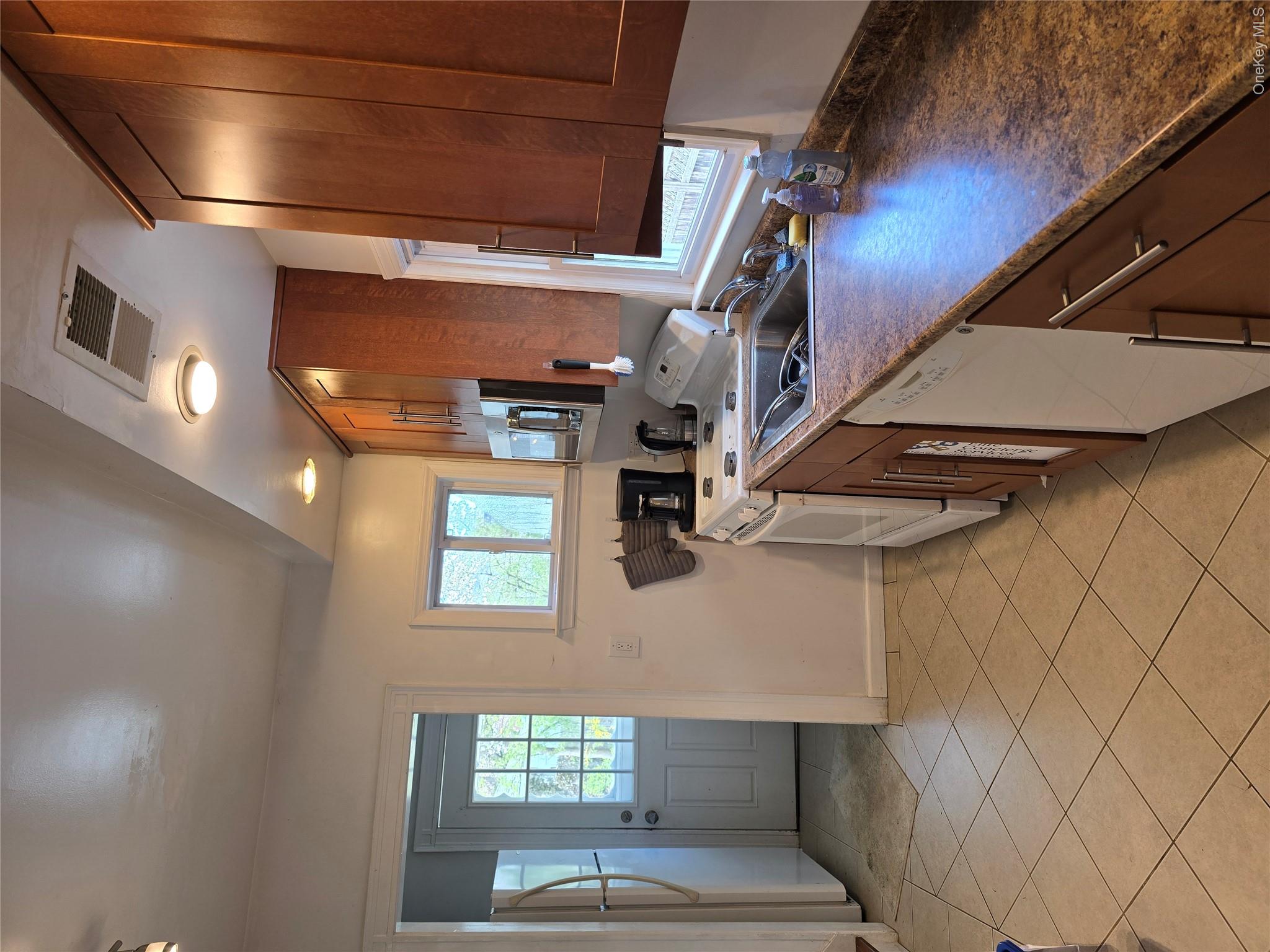 15 Roosevelt Avenue Rye, NY 10580 - Photo 6 of 13 a kitchen with a sink cabinets and window