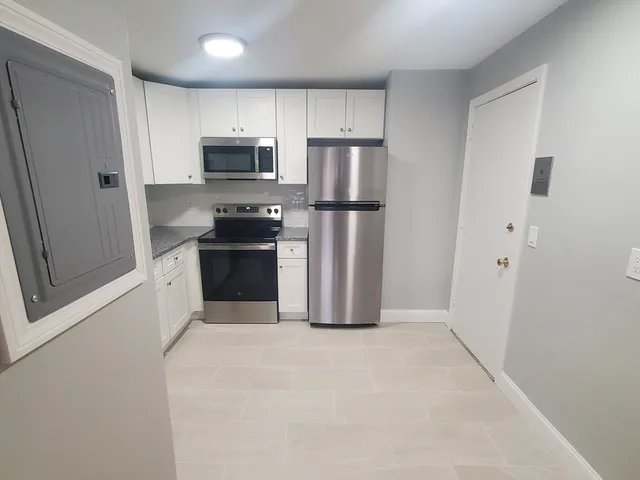 a kitchen with stainless steel appliances a refrigerator and a stove top oven