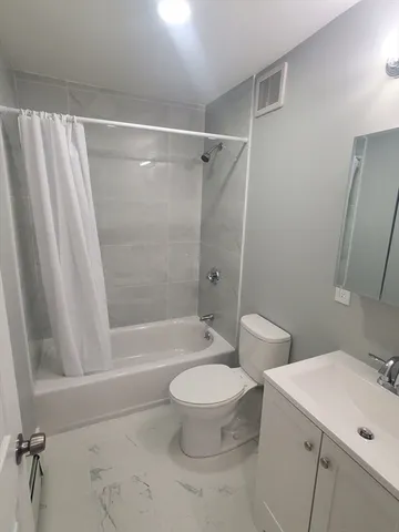 a bathroom with a toilet a sink and a bathtub
