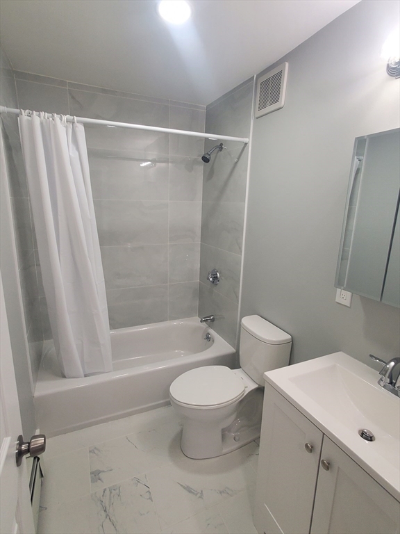 4 Oakcrest Road, Unit 31 Boston, MA 02136 - Photo 7 of 12 a bathroom with a toilet a sink and a bathtub