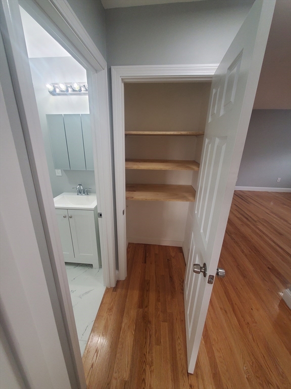 4 Oakcrest Road, Unit 31 Boston, MA 02136 - Photo 10 of 12 a view of a hallway with wooden floor and staircase