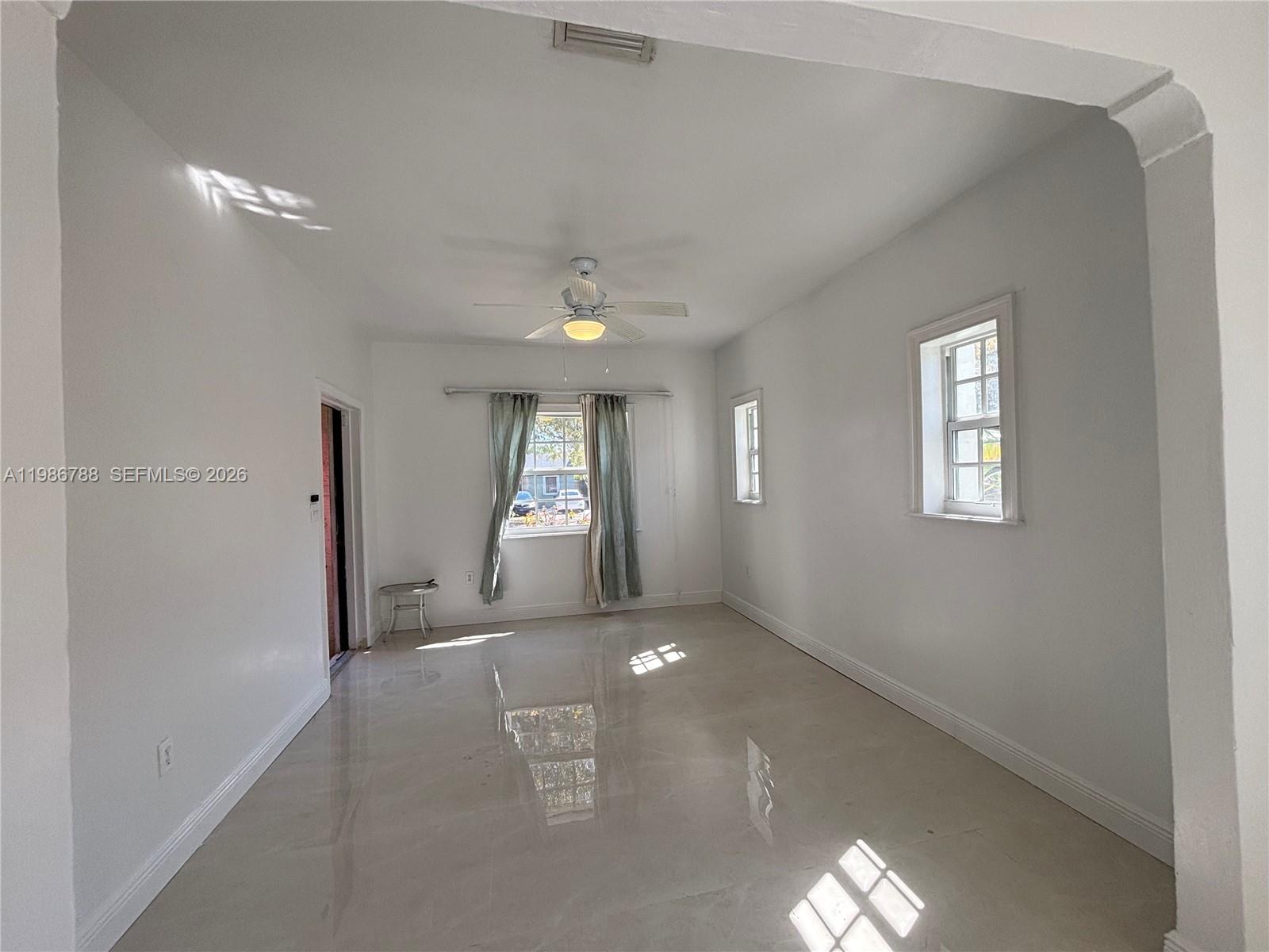 521 Northwest 48th Street Miami, FL 33127 - Photo 13 of 30 a view of a big room with windows and cabinet
