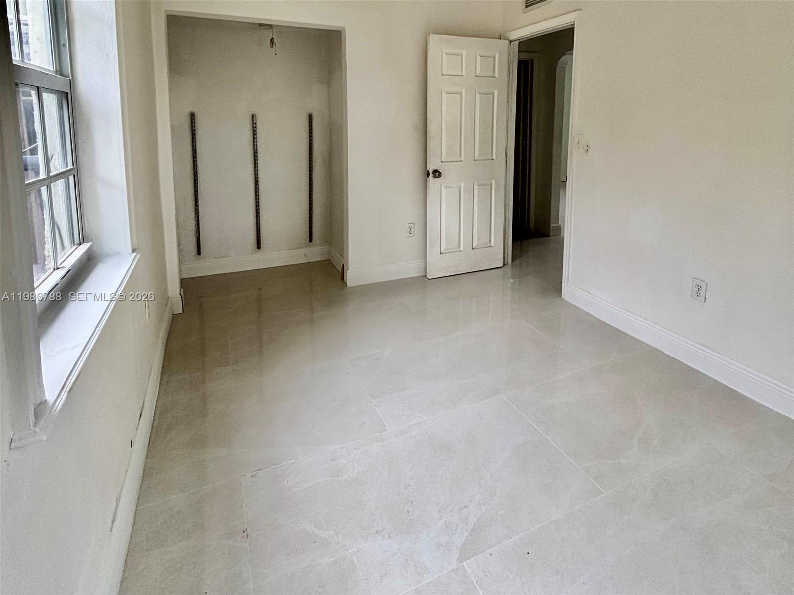 521 Northwest 48th Street Miami, FL 33127 - Photo 15 of 30 an empty room with windows