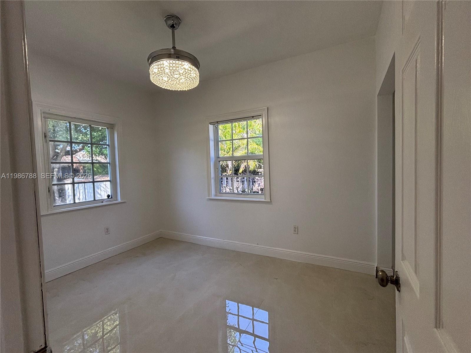 521 Northwest 48th Street Miami, FL 33127 - Photo 18 of 30 a view of an empty room with windows and cabinet