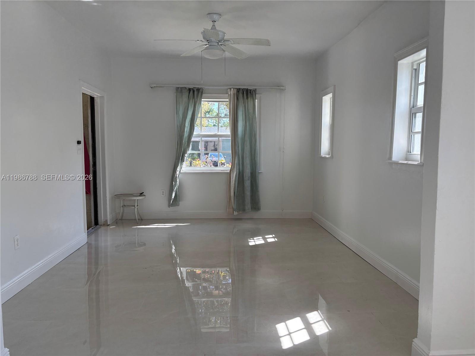521 Northwest 48th Street Miami, FL 33127 - Photo 20 of 30 an empty room with windows