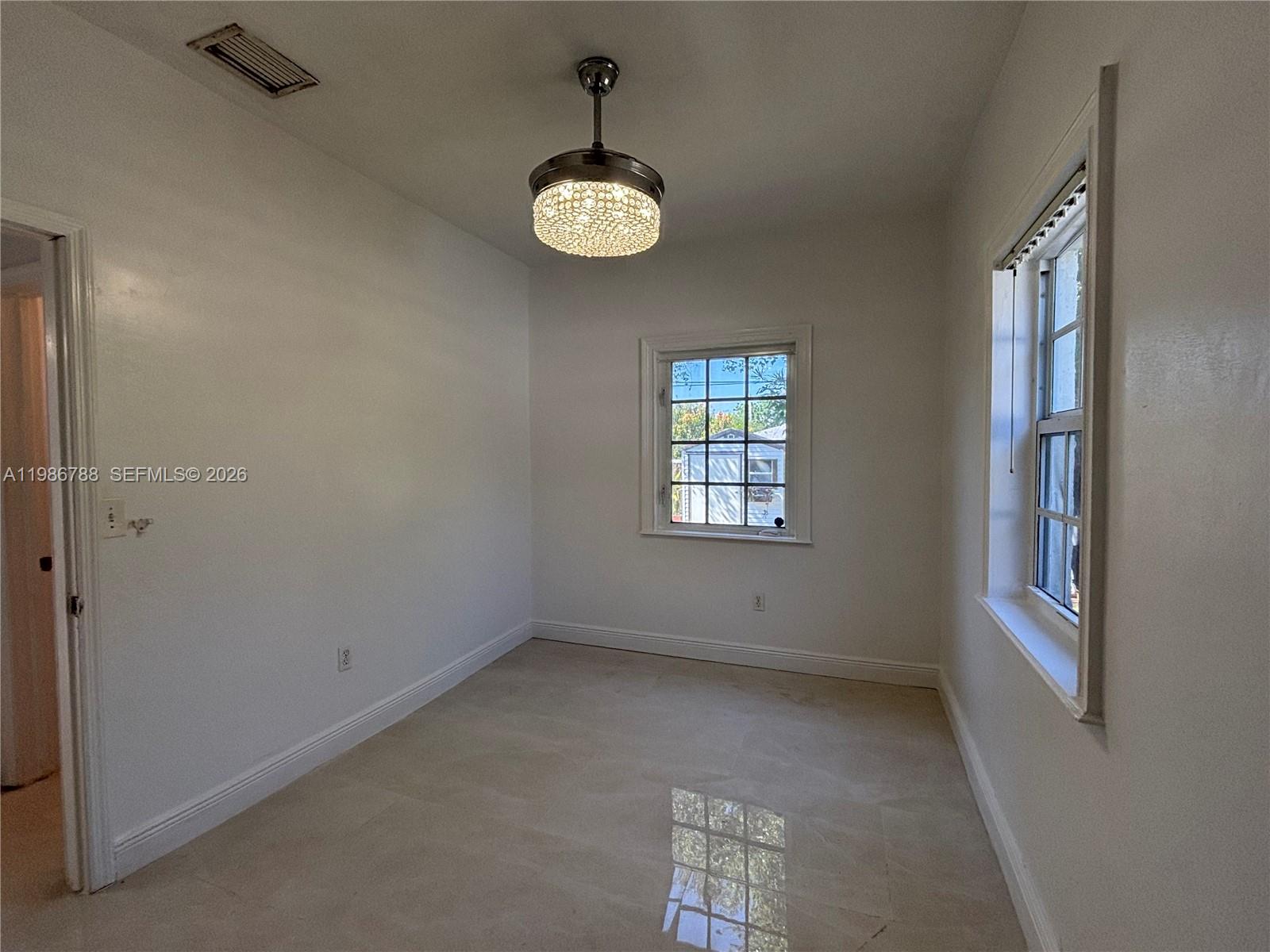 521 Northwest 48th Street Miami, FL 33127 - Photo 22 of 30 an empty room with windows