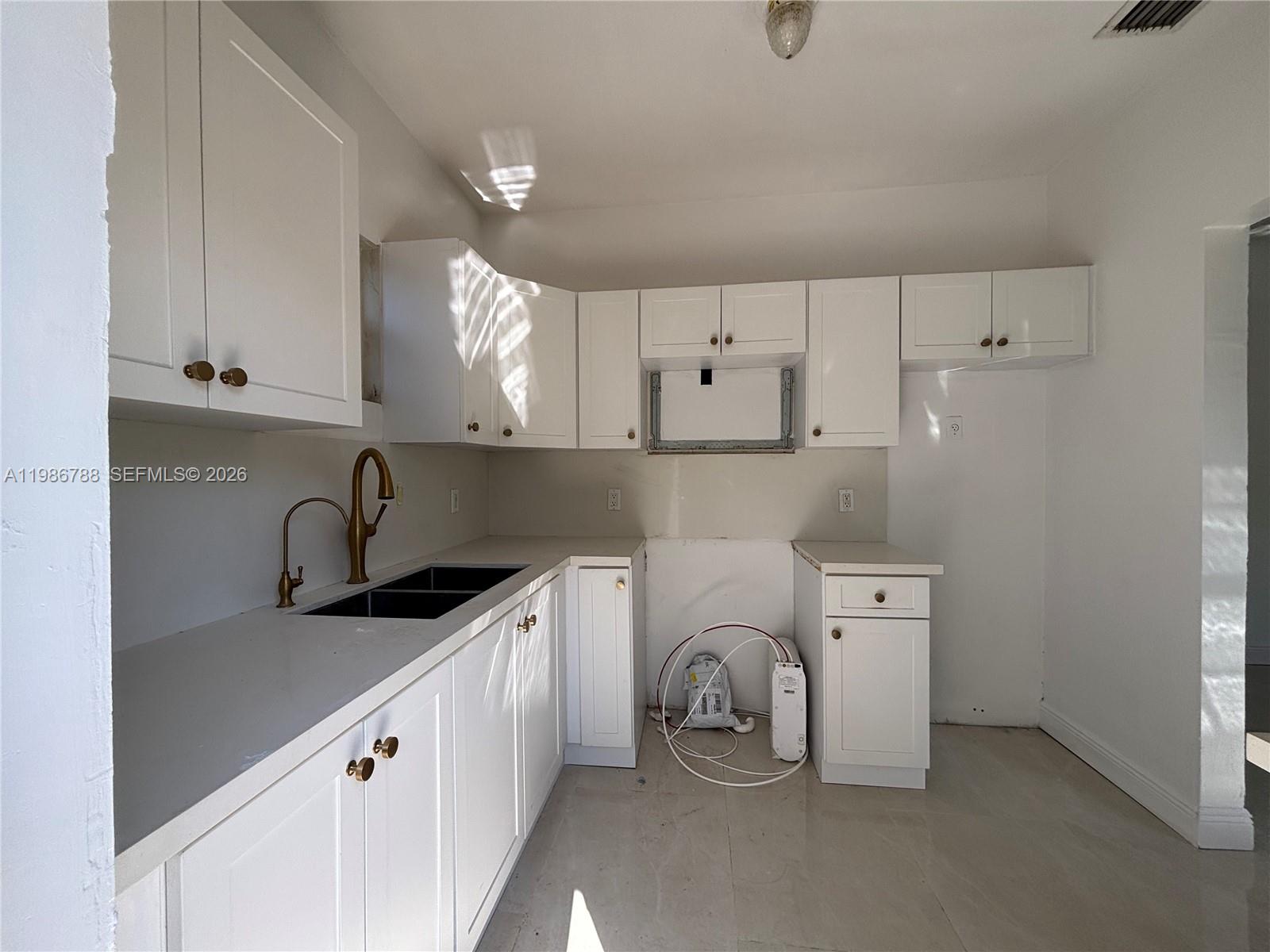 521 Northwest 48th Street Miami, FL 33127 - Photo 6 of 30 a utility room with sink dryer and washer