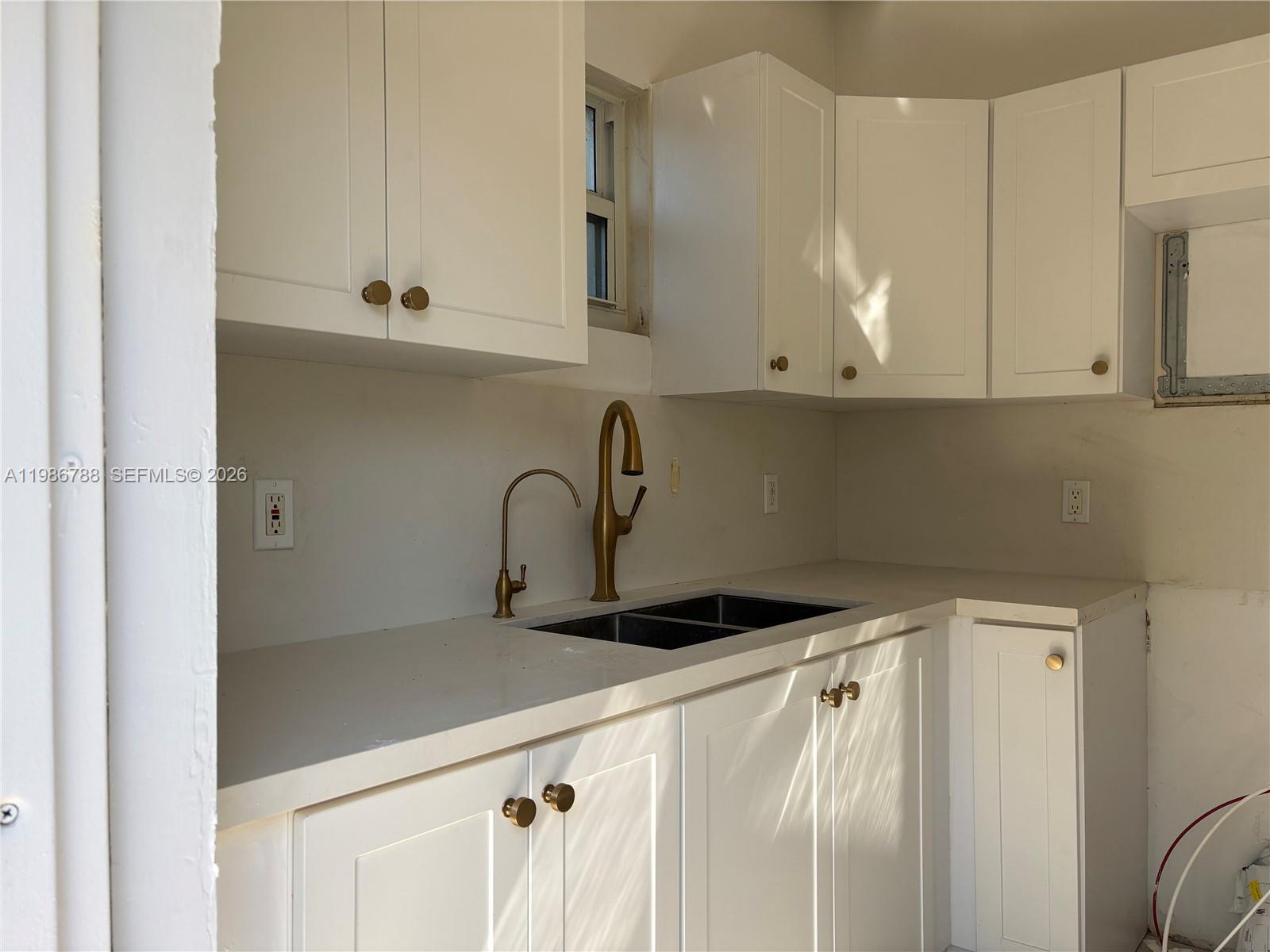 521 Northwest 48th Street Miami, FL 33127 - Photo 7 of 30 a kitchen with stainless steel appliances granite countertop white cabinets and a sink