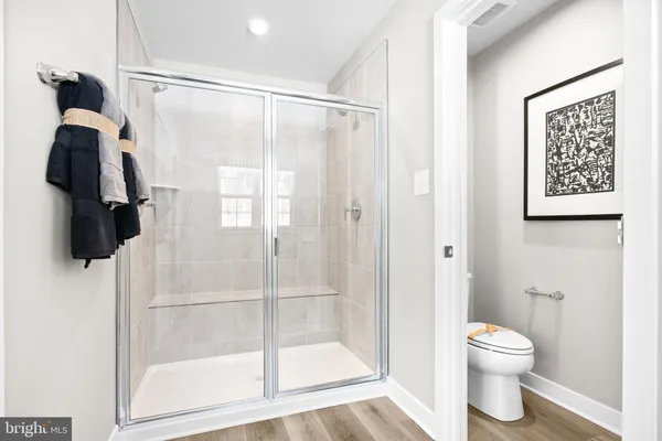 a bedroom with a bed and a night stand