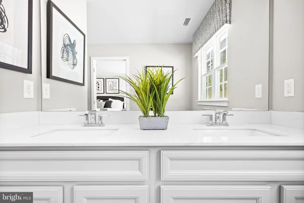 a bathroom with a double vanity sink toilet and shower