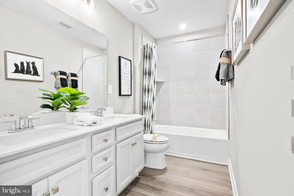 a living room with kitchen island furniture and a wooden floor