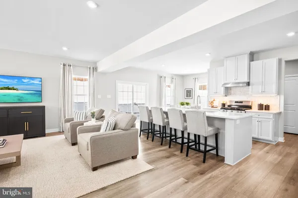 a kitchen with white cabinets and refrigerator
