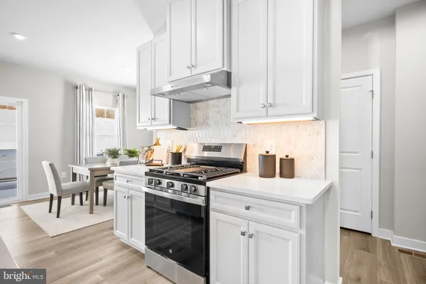 a dining room with wooden floor and a fireplace