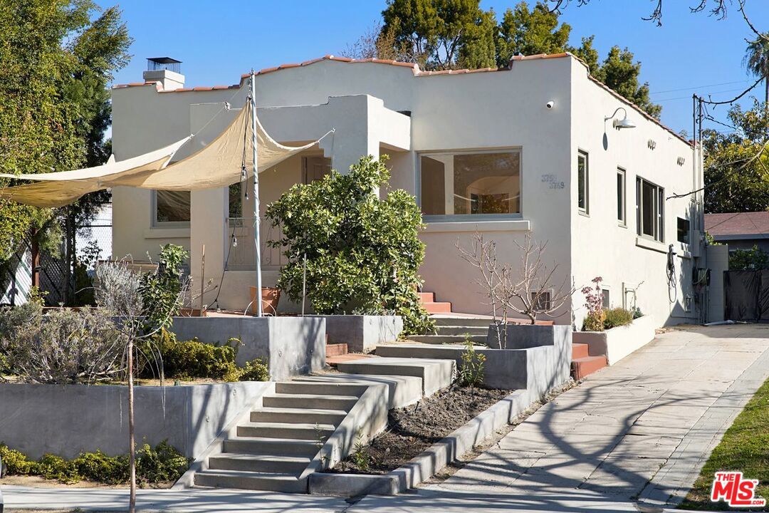 a front view of a house with sitting area