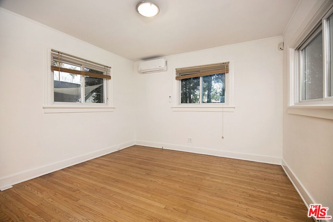3749 Griffith View Drive Los Angeles, CA 90039 - Photo 21 of 34 an empty room with wooden floor and windows