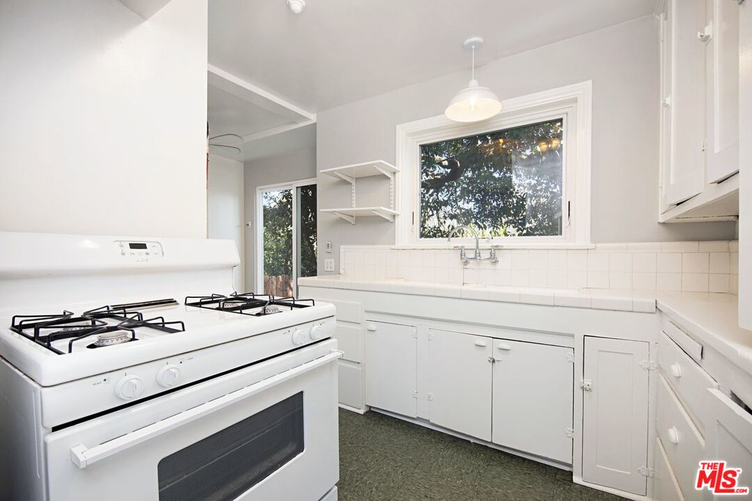 3749 Griffith View Drive Los Angeles, CA 90039 - Photo 25 of 34 a kitchen with white cabinets and white appliances
