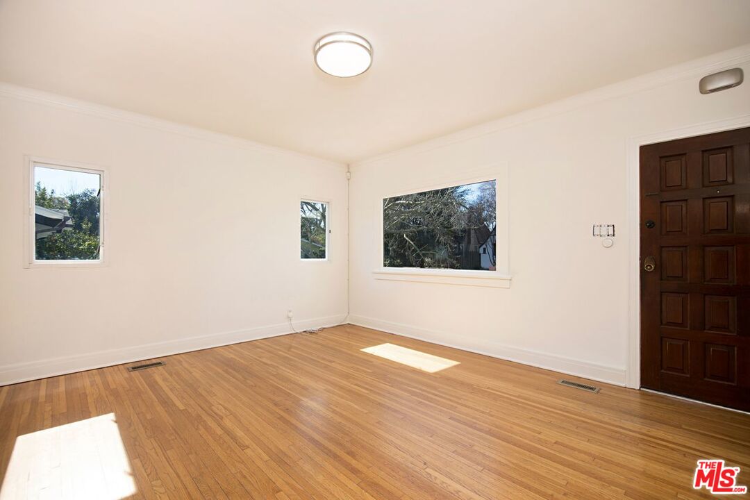 3749 Griffith View Drive Los Angeles, CA 90039 - Photo 6 of 34 a view of an empty room with wooden floor and a window