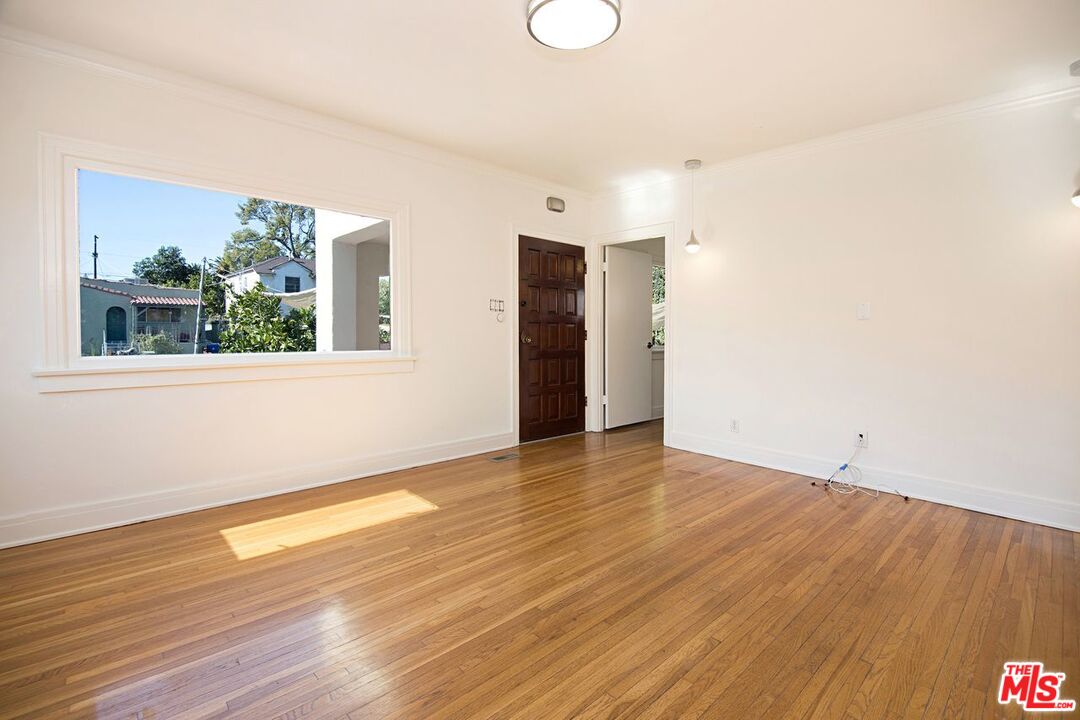 3749 Griffith View Drive Los Angeles, CA 90039 - Photo 7 of 34 a view of an empty room with wooden floor and a window