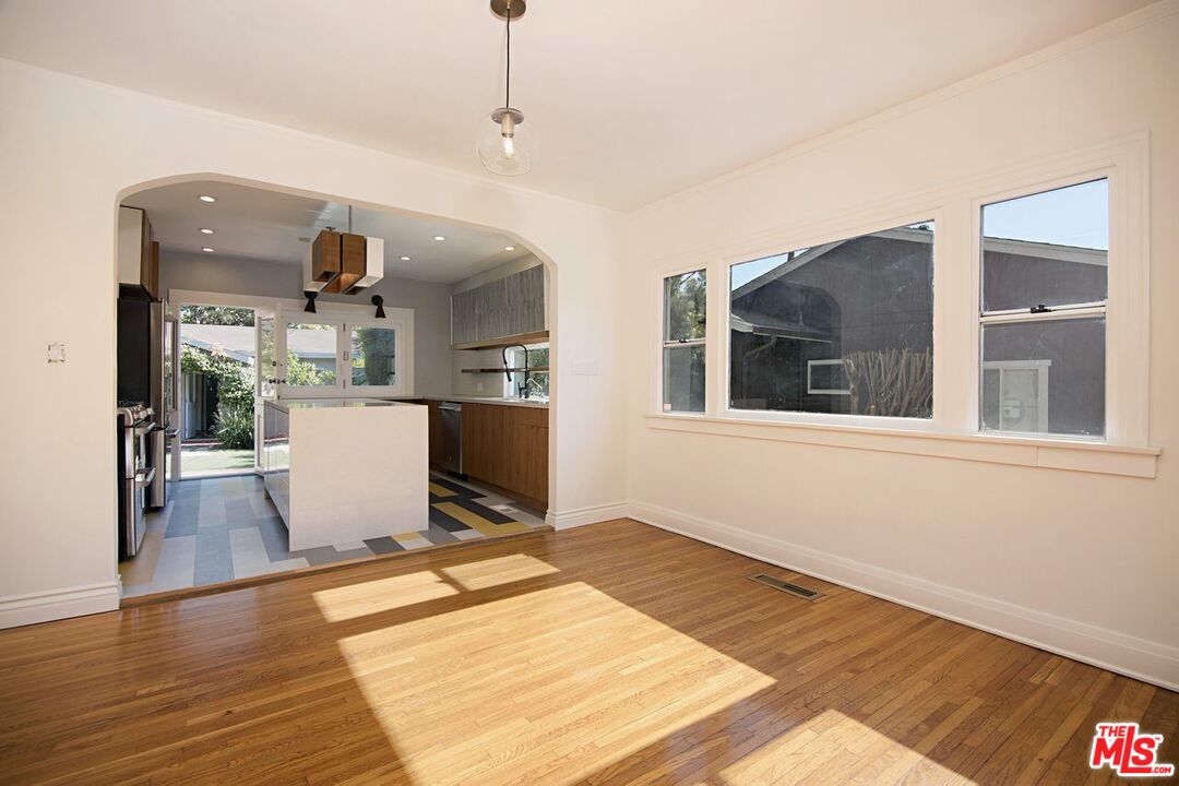 3749 Griffith View Drive Los Angeles, CA 90039 - Photo 8 of 34 a workspace with kitchen island stainless steel appliances wooden floor and living room view